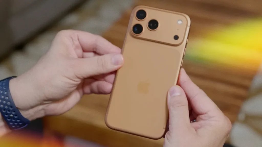 two hands holding a coffee ice cream-colored iPhone 17 Pro
