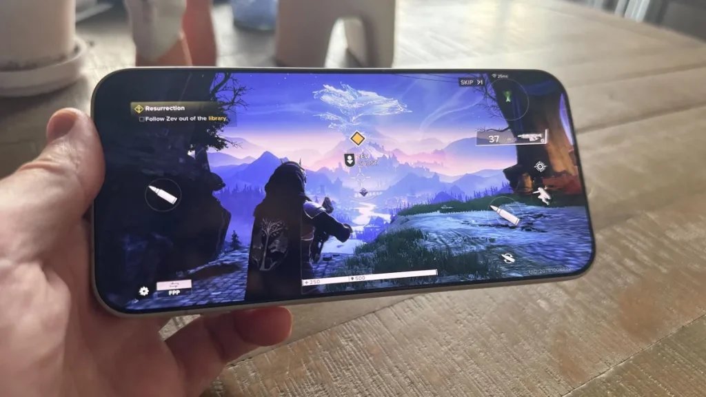 A hand holding a phone that's playing a third-person shooter game.