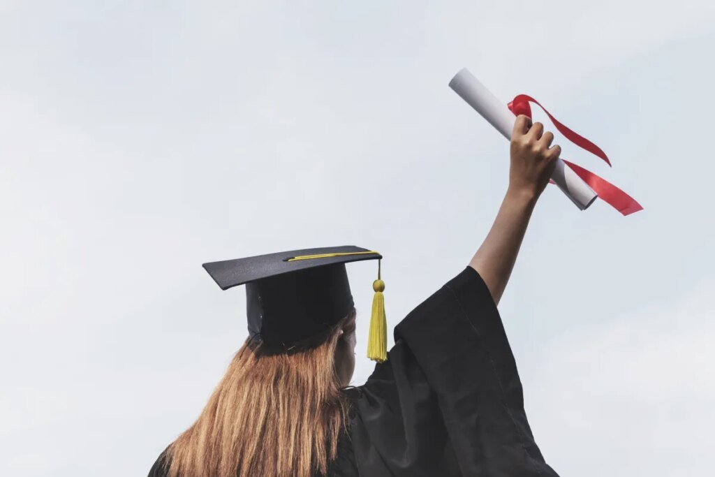 Almost 80 European deep tech university spinouts reached $1B valuations or $100M in revenue in 2025 Rear view of woman in a cap and gown holding a diploma in the air.