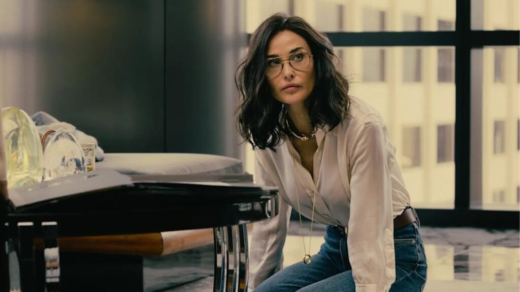 Cami kneels on the floor of Monty's office