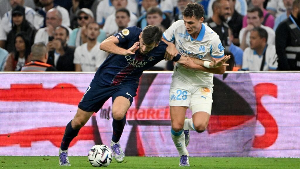 PSG's Khvicha Kvaratskhelia vies with Marseille's Benjamin Pavard