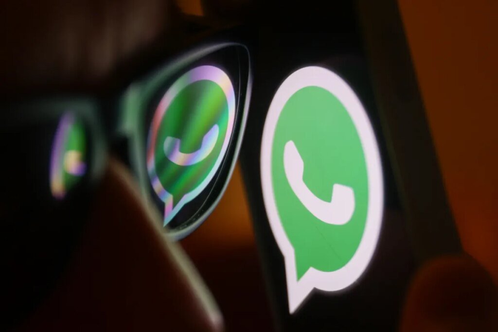 WhatsApp will now charge AI chatbots to operate in Italy WhatsApp logo reflected on sunglasses and displayed on a phone screen.