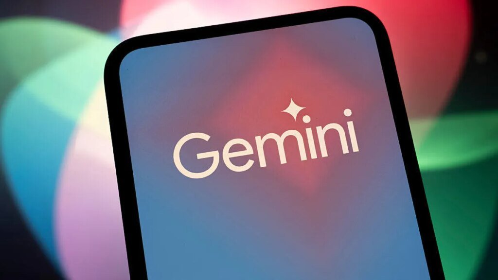 Google Rolls Out Latest AI Model, Gemini 3.1 Pro The Gemini logo appears on a smartphone screen with the Siri logo in the background.