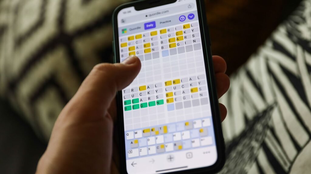 Quordle hints and answers for Sunday, February 22 (game #1490) Quordle on a smartphone held in a hand