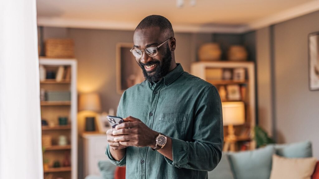 Concerned about privacy on your Android? Here’s why Bitdefender is your all-in-one solution Man holding a smartphone in a room